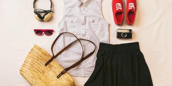 Flat-lay of women's fashion items including clothing, accessories, and shoes