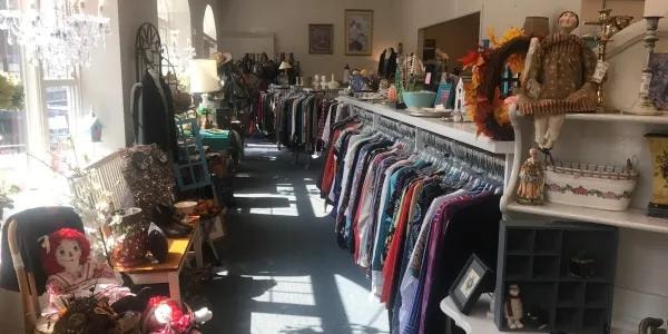 Inside The Buttonhole consignment shop showing clothing racks and decor