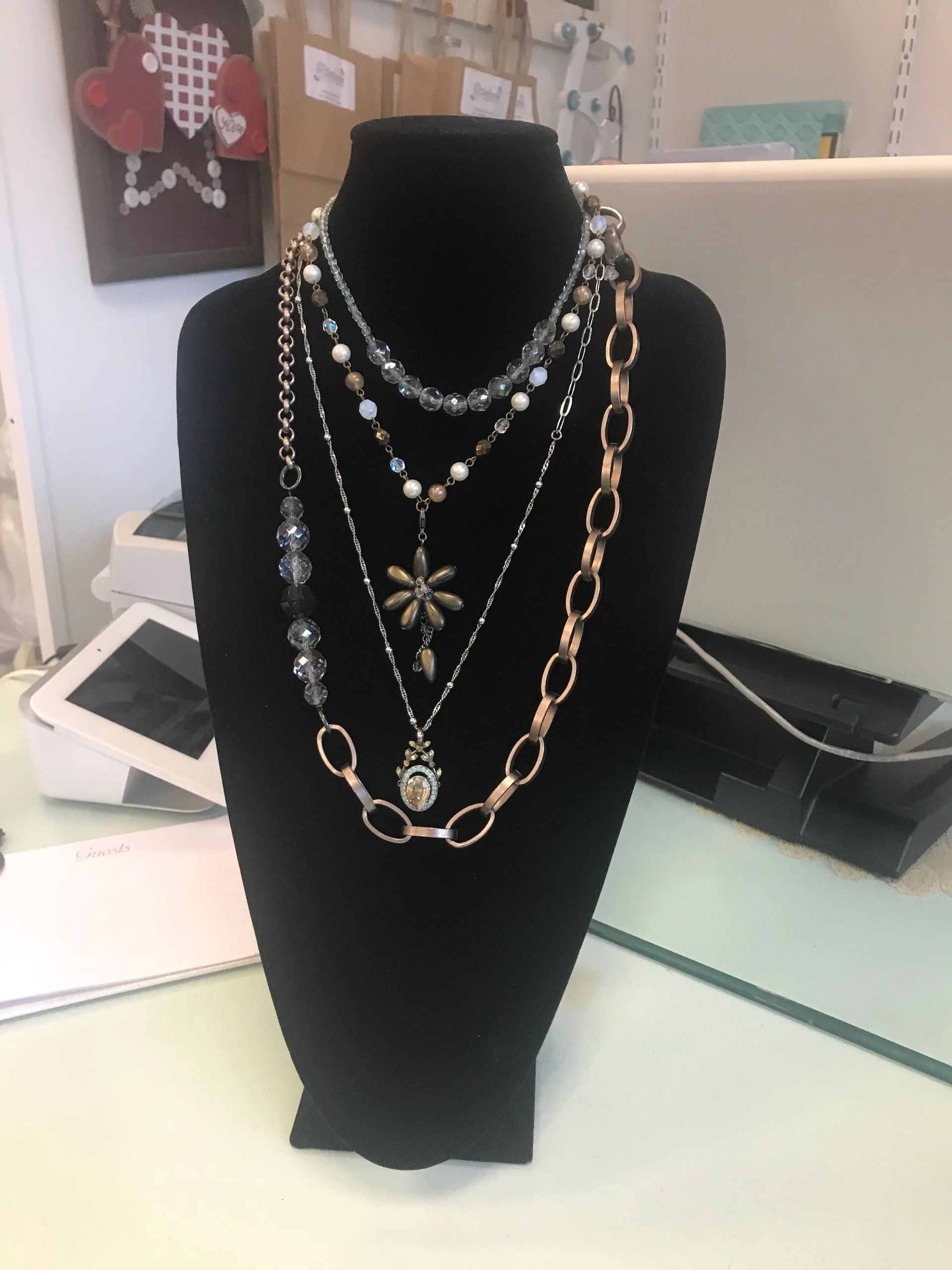 Mannequin bust displaying layered necklaces